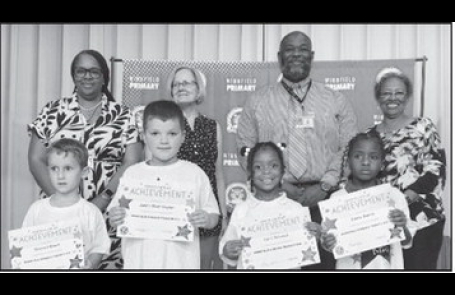 Winnfield Primary School – Kindergarten From left: Bennett Green, Jaxon Worhington, Lyric DeLoach and Chloe Morris. Assistant Principal Resa Johnson, Kiwanian Mary Lou Blackley, Principal Byron King and Kiwanian Ethel Howell.