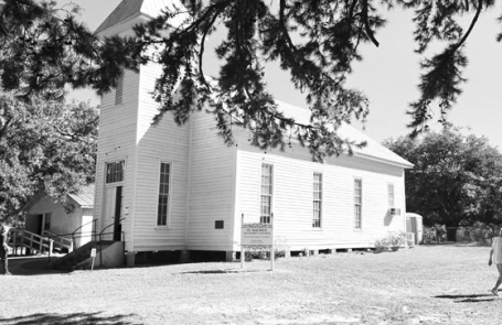 Framed by the boughs of a native Winn Parish shortleaf pine, the historic St. Maurice Methodist Church (built in 1874 by John E. Jones) stands in bright autumn sunlight during the annual cemetery homecoming on Sunday, October 11, 2026.