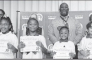 Winnfield Primary School – Second Grade From left: Kaliyah Starks, Noe King, Ariyan King and Andrew Lacour. Assistant Principal Resa Johnson, Kiwanian Mary Lou Blackley, Principal Byron King and Kiwanian Ethel Howell.
