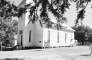 Framed by the boughs of a native Winn Parish shortleaf pine, the historic St. Maurice Methodist Church (built in 1874 by John E. Jones) stands in bright autumn sunlight during the annual cemetery homecoming on Sunday, October 11, 2026.
