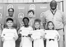 WPS Grade 2 Left to right: Jace Sierra, Deondric Lindsey, Skylar Nelson, Cadence Barthelemy. Assistant Principal Resa Johnson, Kiwanian Margaret Coon, Principal Byron King