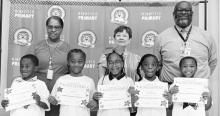 WPS Grade 1 Left to right: Malik Washington, Noe King, Kaliyah Starks, Tailyn McFarland, Jayden Rhone, Assistant Principal Resa Johnson, Kiwanian Margaret Coon, Principal Byron King