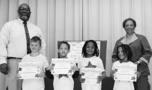 Winnfield Primary School Grade 4 Left to right: Maisy Carson, Christian Crafts, Jeannie Tolbert. Principal Byron King and Kiwanian Ethel Howell