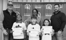 WPS 2nd Grade Left to right: Ja’Miya Jones, A’Mya Brown, River Spivey, Thomas Guin. Kiwanian Sheriff Josh McAllister, Assistant Principal Resa Johnson, Kiwanian Chet Atkins.