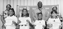 Winnfield Primary School – First Grade From left: Gabrielle Breaux, Sadie Garrett, Dixxie Hernandez and Ellie Stroud.. Assistant Principal Resa Johnson, Kiwanian Mary Lou Blackley, Principal Byron King and Kiwanian Ethel Howell.