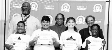 WINNFIELD PRIMARY SCHOOL-Grade 4 Left to right: Jaidyn Adams, Abe Rustom, Della Jean Etheridge, Yasir White. Principal Byron King, Assistant Principal Resa Johnson, Kiwanian Ethel Howell
