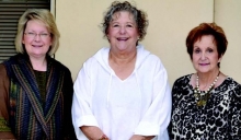 Winn Chamber of Commerce and Tourism Board MembersAleta Hoffman, Ellen Russell and June Melton stand besidea delivered fern in front of Timberman’s in DowntownWinnfield.