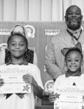 Winnfield Primary School – First Grade From left: Gabrielle Breaux, Sadie Garrett, Dixxie Hernandez and Ellie Stroud.. Assistant Principal Resa Johnson, Kiwanian Mary Lou Blackley, Principal Byron King and Kiwanian Ethel Howell.