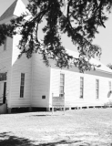 Framed by the boughs of a native Winn Parish shortleaf pine, the historic St. Maurice Methodist Church (built in 1874 by John E. Jones) stands in bright autumn sunlight during the annual cemetery homecoming on Sunday, October 11, 2026.